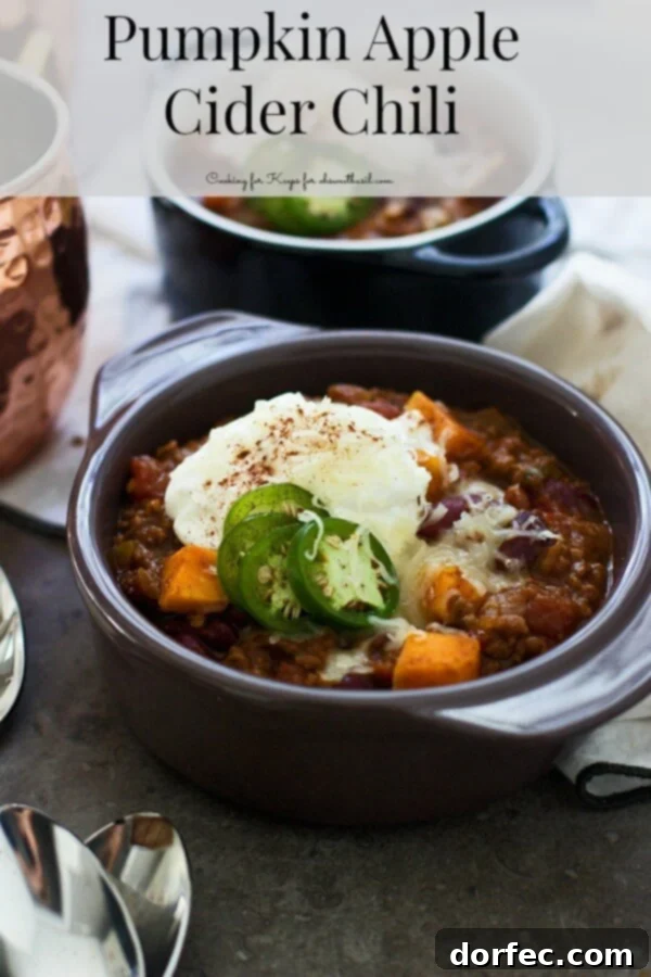 Pumpkin Apple Cider Chili Delicious Pumpkin Apple Cider Chili served in a bowl, garnished with fresh herbs, perfect for autumn