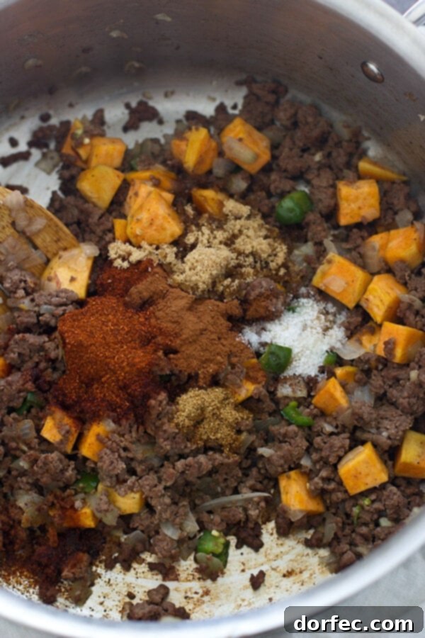 Pumpkin Apple Cider Chili Close-up of the rich and colorful Pumpkin Apple Cider Chili simmering in a pot