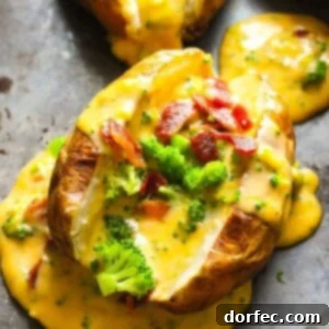 A beautifully presented loaded baked potato with homemade cheese sauce.