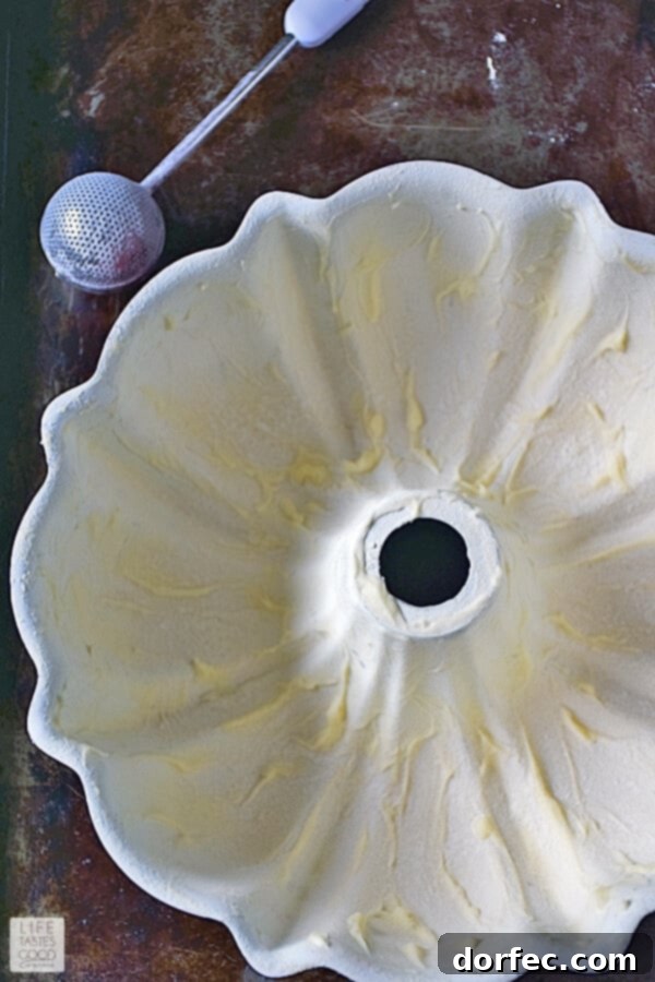 Bundt pan meticulously buttered and floured, ready for cranberry cake batter.