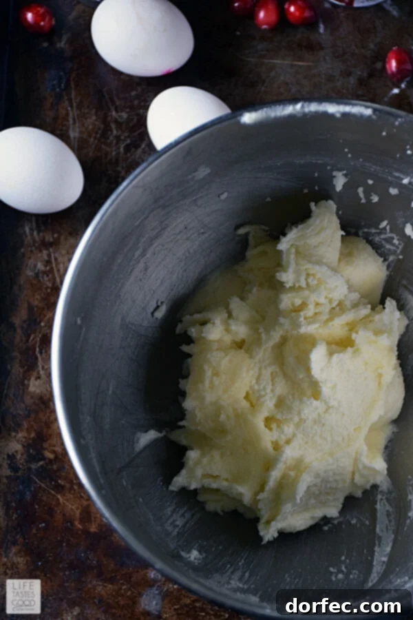 Creamed butter and sugar mixture, light and fluffy, ready for egg addition.