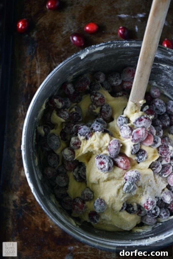 Delicious cranberry bundt cake batter with fresh cranberries folded in.