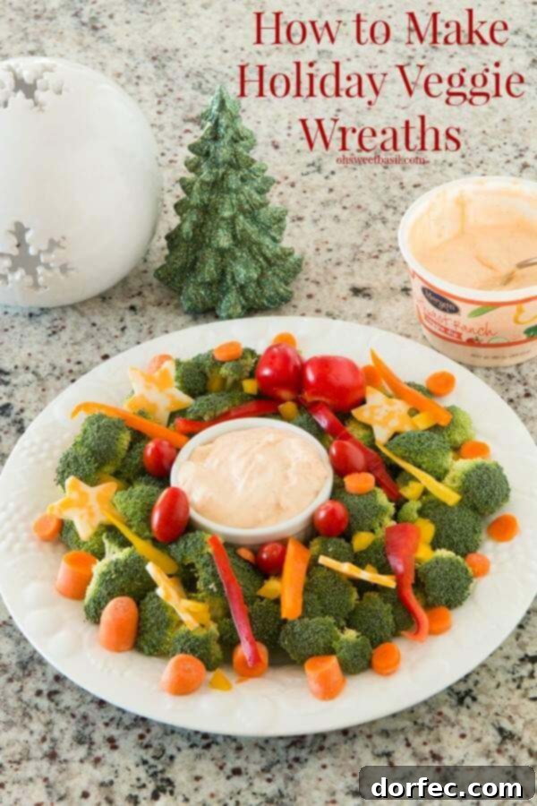 Brightly colored vegetable wreath with dip in the center, perfect for a healthy holiday party appetizer.