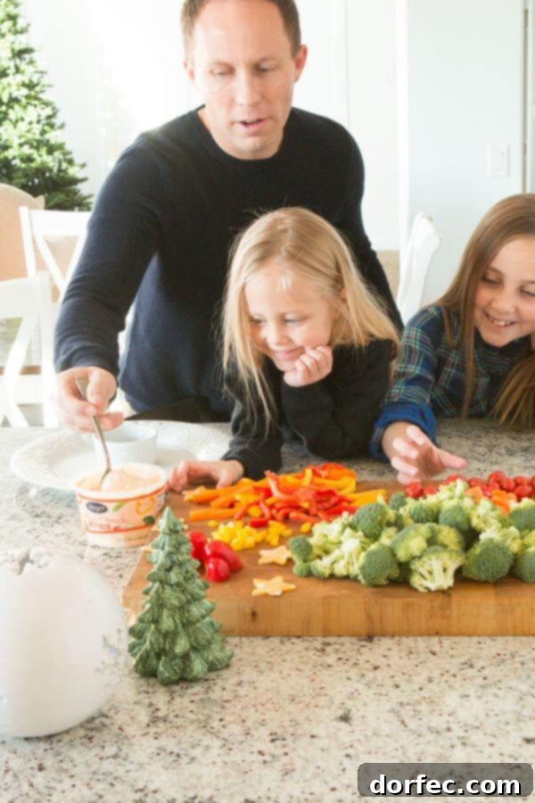 Colorful assortment of fresh vegetables arranged in a wreath shape with a bowl of dip, ideal for holiday entertaining.