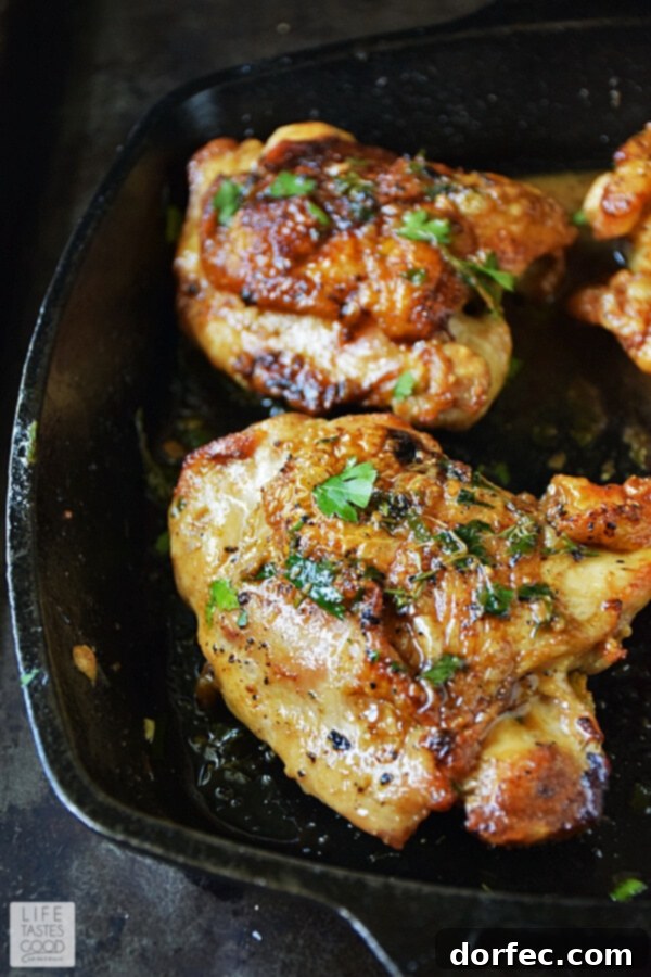A beautifully plated serving of pan-roasted chicken in herb butter sauce, garnished with fresh herbs, showcasing the crispy skin and rich golden sauce. This enticing meal is ready to be enjoyed, promising a delightful culinary experience.