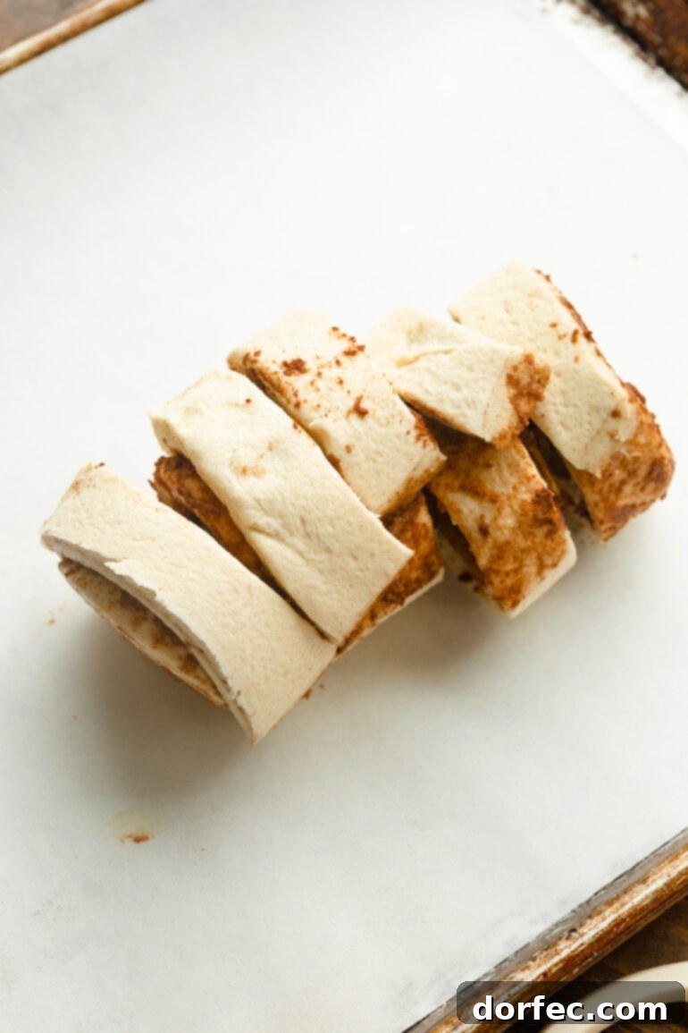 Cinnamon Roll Sausage Poppers 5 A photo showcasing five individual sections of uncooked, store-bought cinnamon roll dough, neatly separated and ready for preparation. This highlights the convenience of using pre-made ingredients for an easy breakfast.