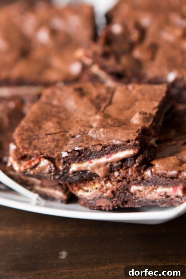 A festive platter of easy Ghirardelli peppermint bark brownies, cut into squares and ready for serving.