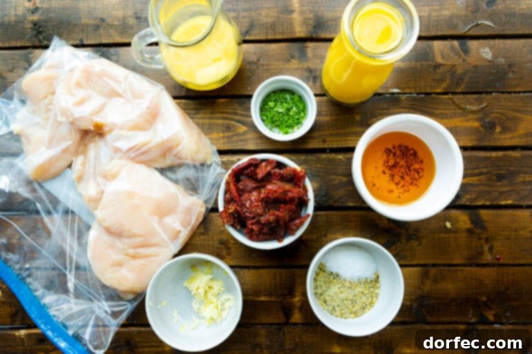 A selection of ingredients for the citrus Greek chicken marinade and sauce laid out on a kitchen counter.