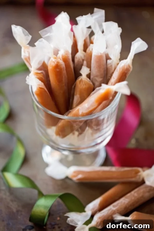 Wrapped Homemade Caramels for Gifting A pile of wax-paper wrapped microwave caramels, neatly arranged and ready for gifting or storage.