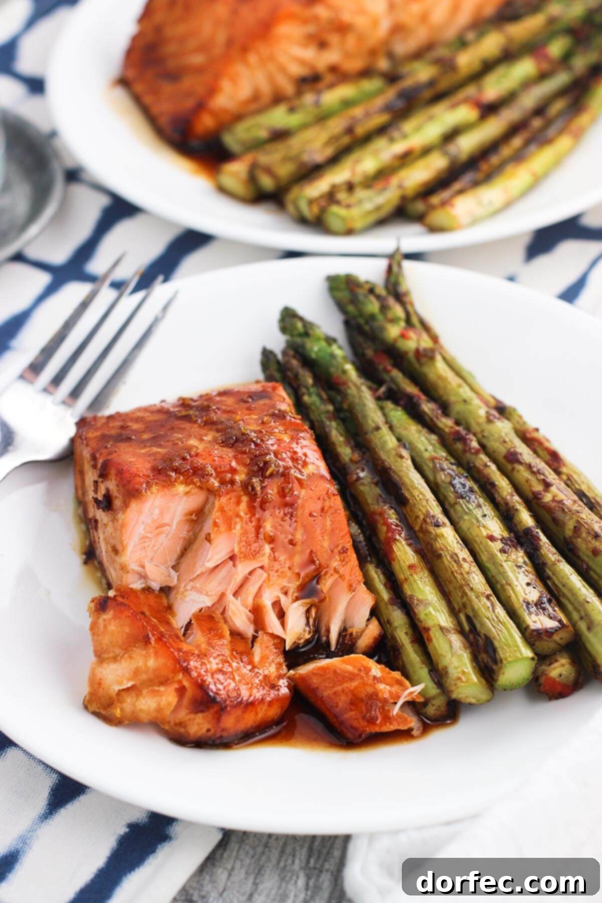 Close-up of baked sweet and spicy orange salmon, showcasing its glazed, crispy edges and vibrant color.