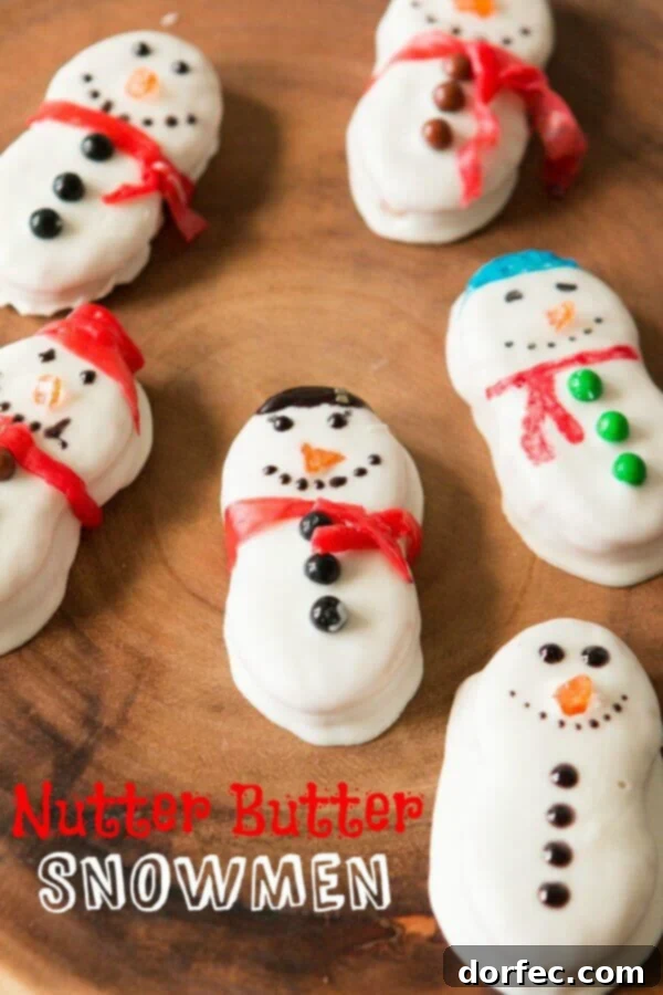 Adorable Nutter Butter Snowmen dipped in white chocolate, ready for a festive Christmas party