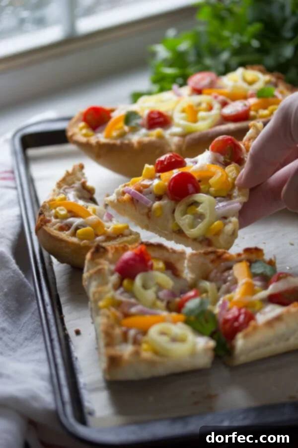 Toppings being added to Santa Fe French Bread Pizza: corn, peppers, onions, tomatoes
