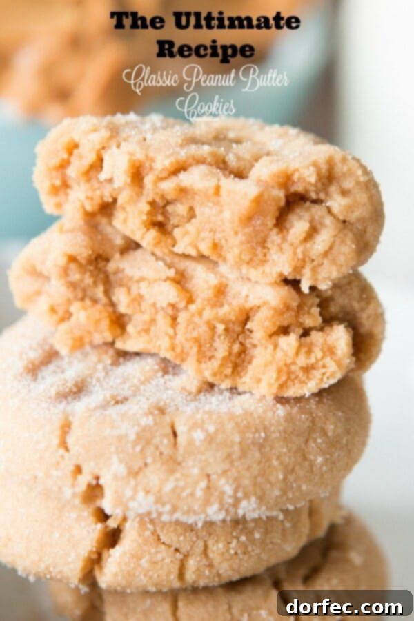 A close-up shot of a stack of fluffy, classic peanut butter cookies with the signature fork marks, emphasizing their soft texture and homemade goodness. The ultimate recipe from ohsweetbasil.com