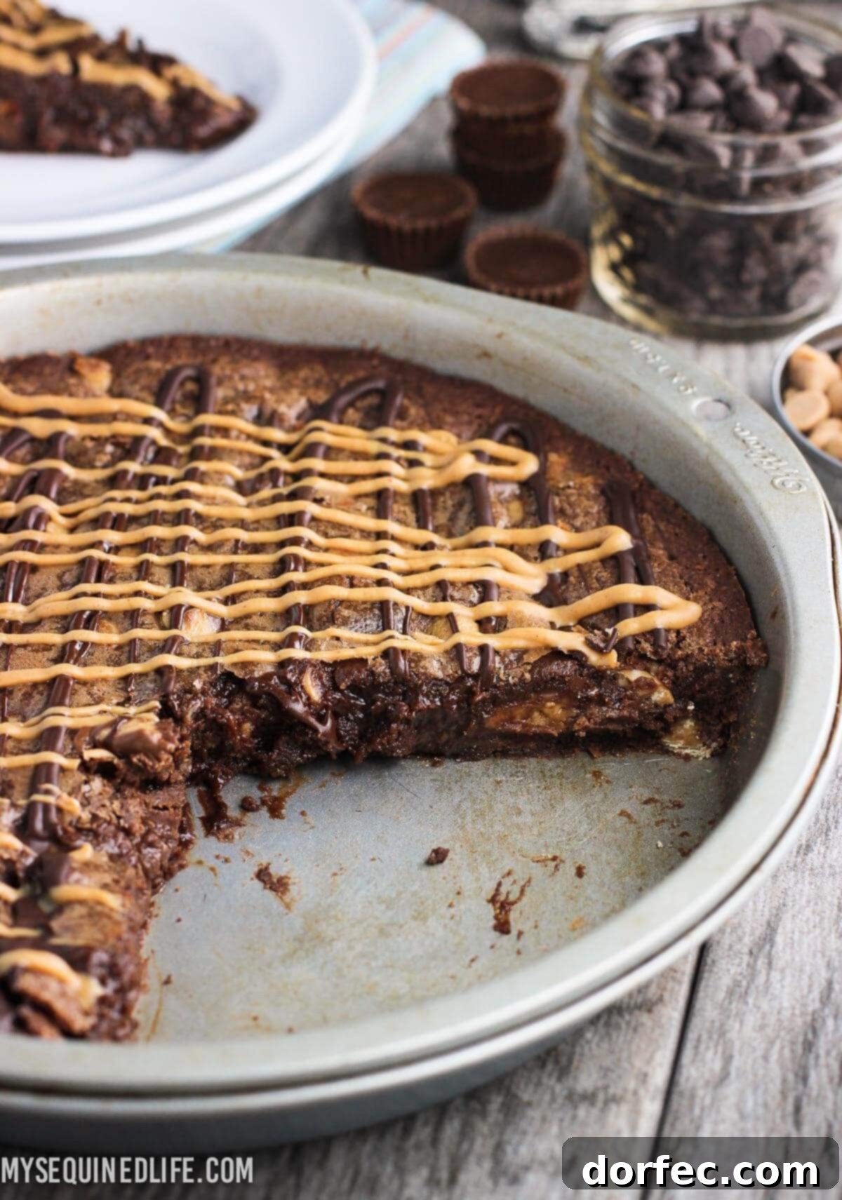 A freshly baked Fudgy Peanut Butter Brownie Cake, sliced and ready to serve, showcasing its rich texture and topping.