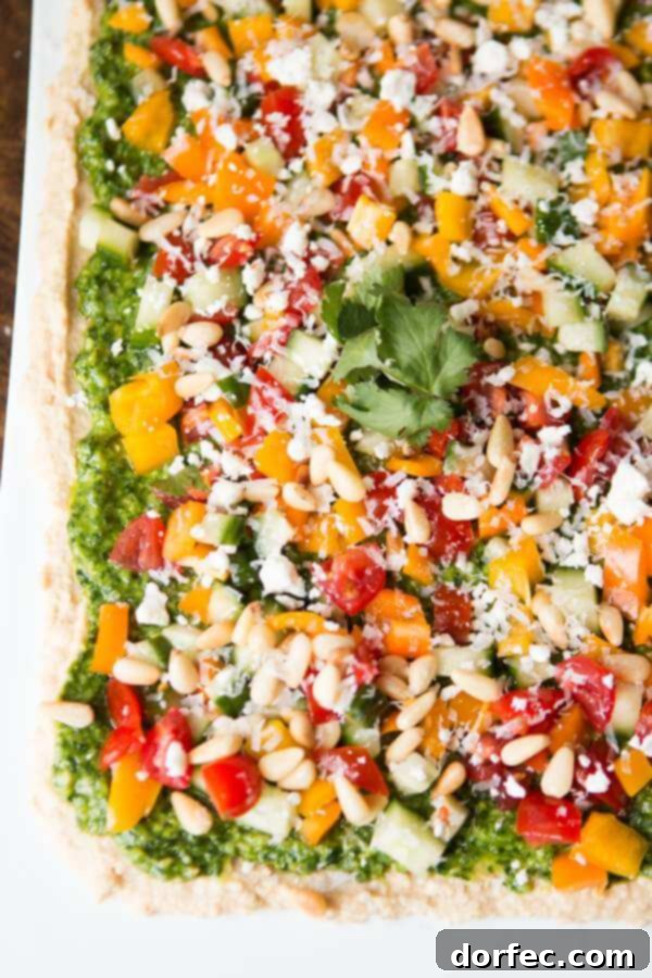 Delicious 8 layer hummus dip with pita chips, a perfect Mediterranean appetizer or snack
