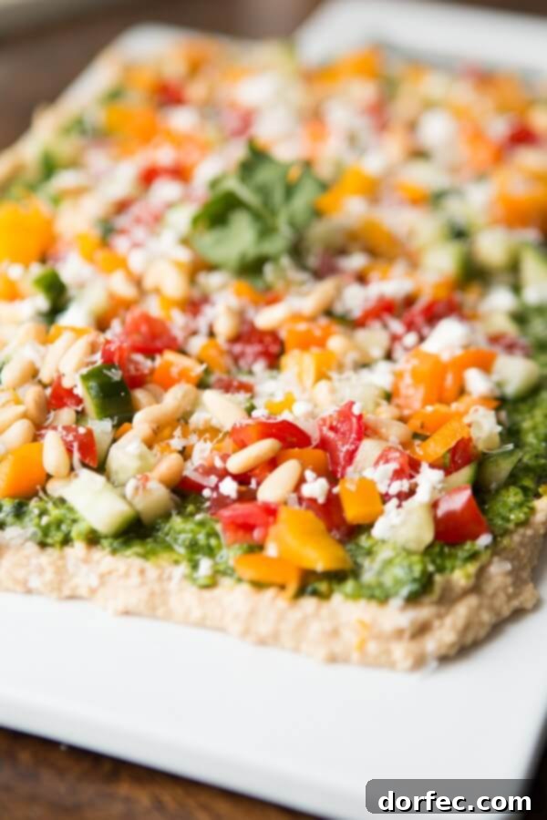 Creamy hummus base topped with vibrant cilantro pesto for an 8 layer dip