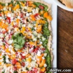 8 layer hummus dip with cilantro pesto, a delightful Mediterranean appetizer