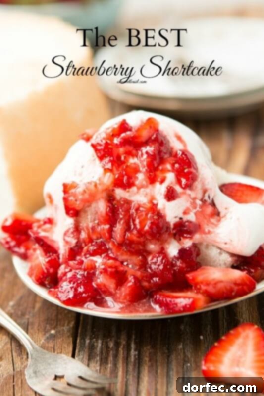 A tall, fluffy slice of Angel Food Cake, perfectly light and airy, served with fresh strawberries for a classic dessert.