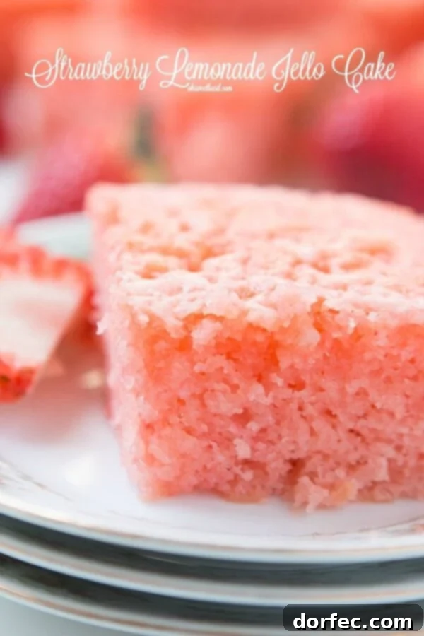 Close-up of the moist, vibrant pink crumb of the Lemon Strawberry Jello Cake, showing the infusion of the lemon glaze.