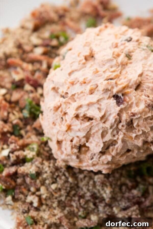 Irresistible BBQ Bacon Cheese Ball with a savory and sweet pecan coating