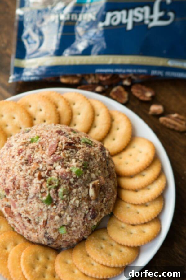 Golden brown sugar bacon adding a sweet and savory crunch to the cheese ball