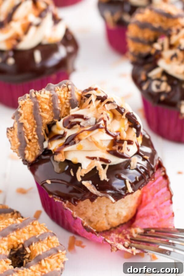 Close-up of a Samoa Cupcake showing the intricate layers of ganache, caramel buttercream, and toasted coconut.