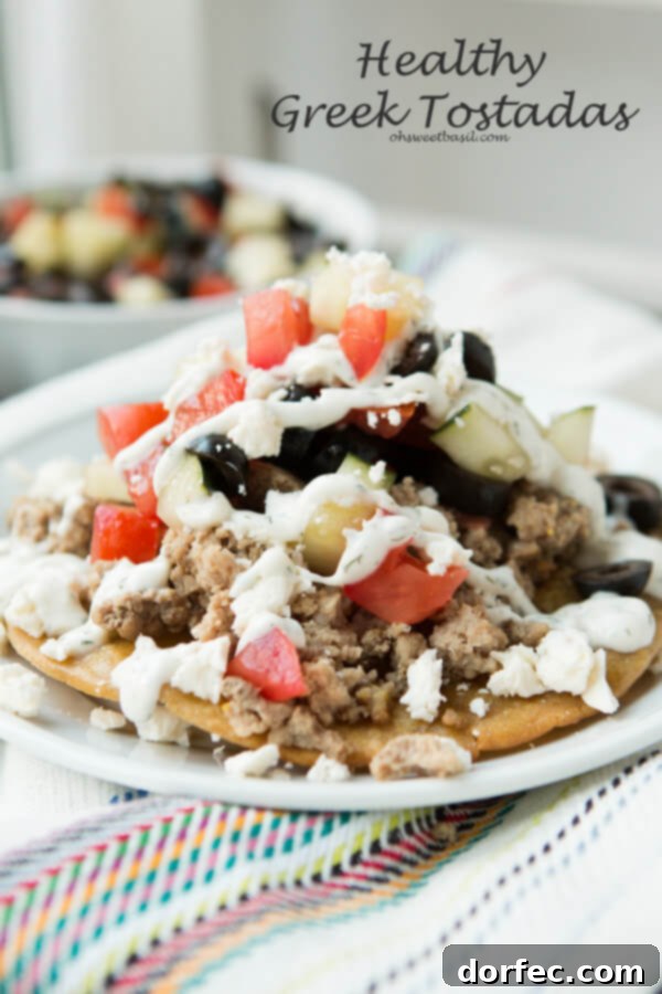 Crispy Greek Tostadas topped with lemon tzatziki sauce and fresh ingredients.