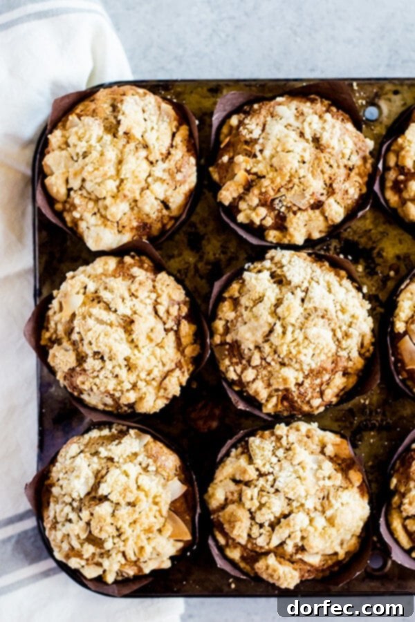 Moist Carrot Cake Muffins with Sweet Crumb Topping Deliciously moist carrot cake muffins with a generous crumb topping, perfect for any occasion.