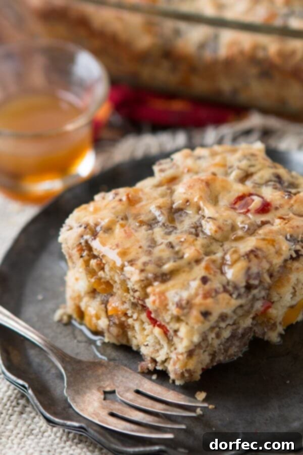 Irresistible Southern Sausage Breakfast Cake A tantalizing overhead shot of a freshly baked Southern Sausage Breakfast Cake, sliced and adorned with the irresistible maple butter sauce, ready to be served for a hearty breakfast or brunch.