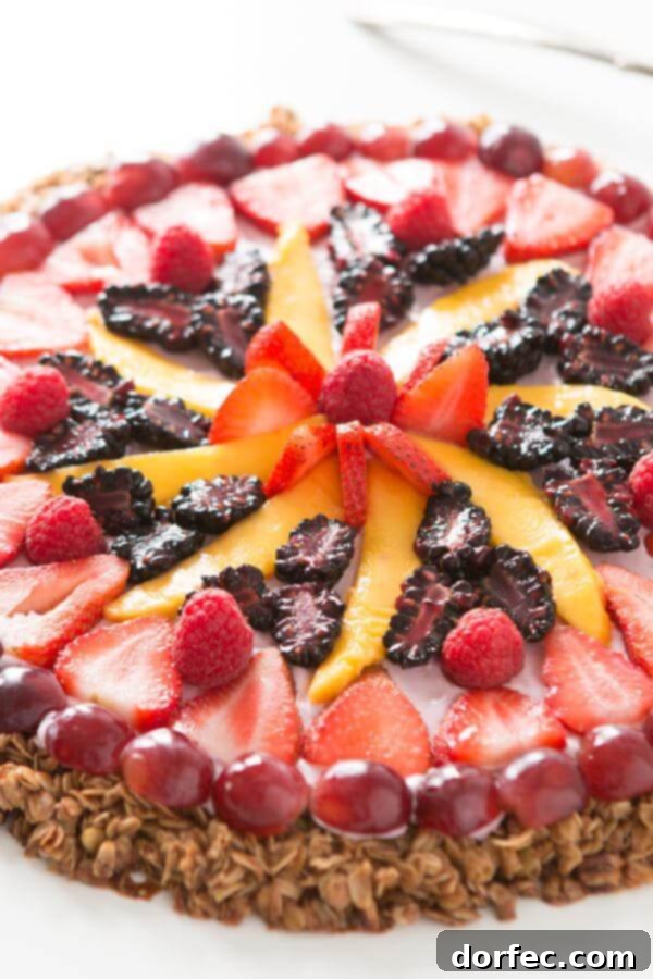 This breakfast fruit and yogurt pizza has become one of our all time favorite recipes. Easy, crunchy granola, creamy mixed berry "sauce" and fruit! ohsweetbasil.com
