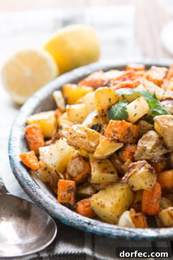 One of our favorite side dishes can also be made into a simple main dish! Roasted root vegetable side dish with simple herbs! Whole 30, paleo, gluten-free, dairy-free roasted root vegetables in serving bowl next to spoon
