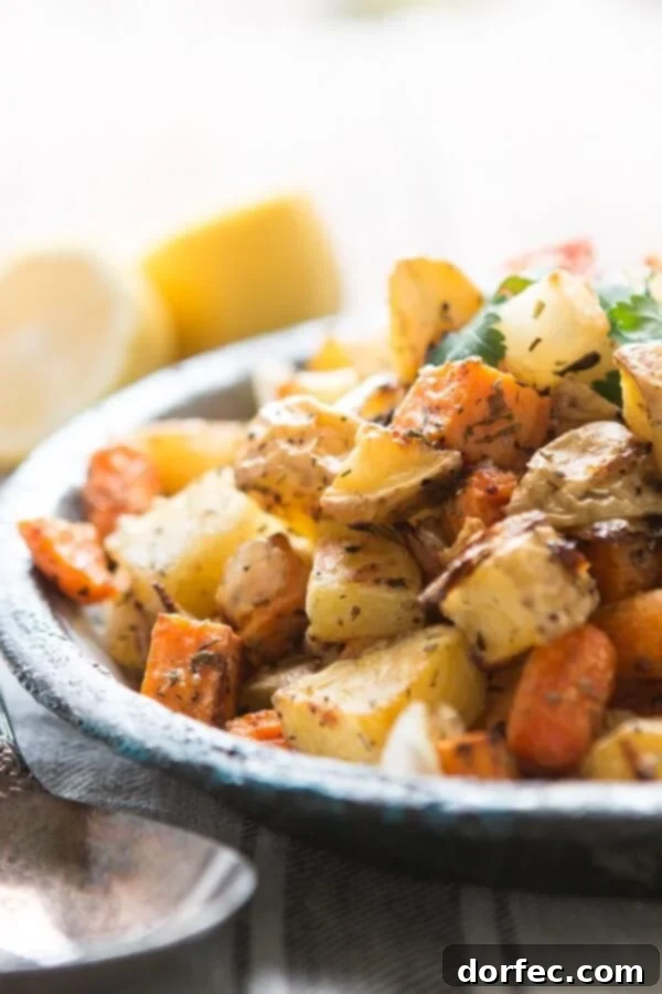 One of our favorite side dishes can also be made into a simple main dish! Roasted root vegetable side dish with simple herbs! Whole 30, paleo, gluten-free, dairy-free veggie side dish on large plate next to spoon