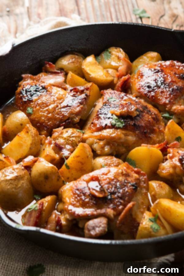 Juicy, saucy Dijon braised chicken thighs with potatoes in a cast iron skillet, a perfect one-skillet dinner.
