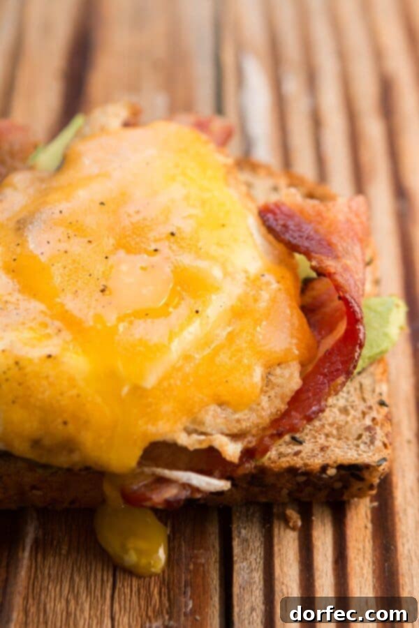 Bacon and Egg Avocado Toast: Savory Breakfast Close-up of Bacon and Egg Avocado Toast with a perfectly runny yolk.