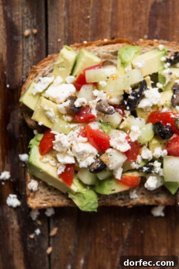 Greek Salad Avocado Toast: Healthy Lunch Idea Fresh Greek Salad Avocado Toast with feta, olives, cucumber, and tomatoes.