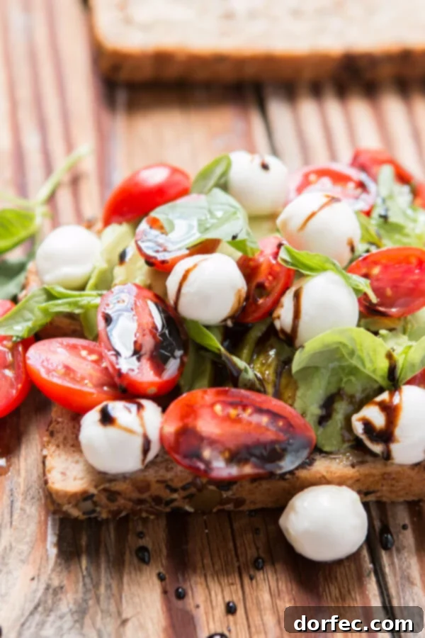 Delicious Caprese Avocado Toast Caprese Avocado Toast, featuring mozzarella pearls and balsamic reduction.