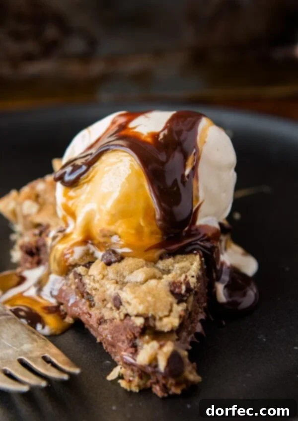 Nutella Dulce de Leche Chocolate Chip Cookie Pie - The Ultimate Dessert Mashup A slice of Nutella Dulce de Leche Chocolate Chip Cookie Pie with a scoop of ice cream on top, ready to be enjoyed.