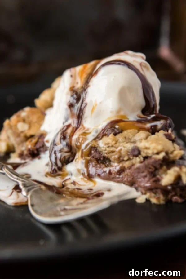 The Golden Top: Gooey Chocolate Chip Cookie Dough with Sea Salt A baked Nutella Dulce de Leche Chocolate Chip Cookie Pie, garnished with a sprinkle of sea salt, ready to be sliced.