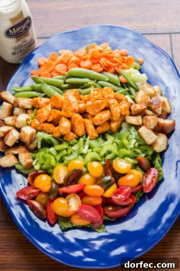 A vibrant Buffalo Chicken Salad with crisp lettuce, fresh vegetables, tender buffalo chicken, and a generous drizzle of blue cheese dressing. ohsweetbasil.com A vibrant Buffalo Chicken Salad with crisp lettuce, fresh vegetables, tender buffalo chicken, and a generous drizzle of blue cheese dressing. ohsweetbasil.com