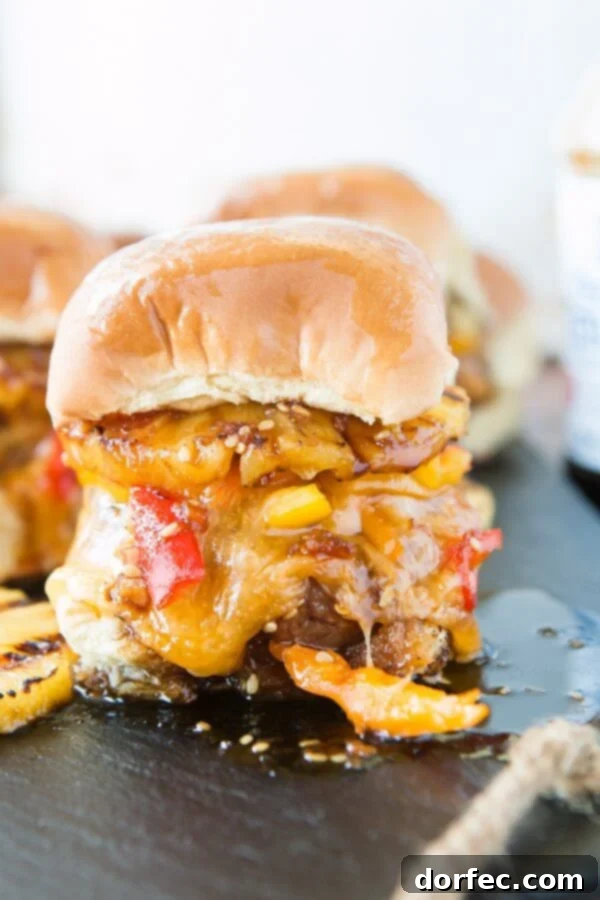 Close-Up of a Mouthwatering Hawaiian Turkey Burger Slider Hand holding a perfectly grilled Hawaiian Turkey Burger Slider, showcasing the melted cheese, juicy turkey patty, and caramelized pineapple, with teriyaki sauce glistening.