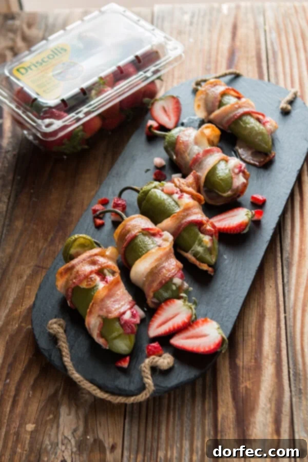 Bacon wrapped strawberry stuffed jalapenos with vibrant strawberries and crispy bacon, ready to be served as a summer appetizer