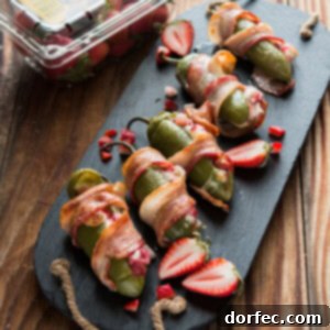 Bacon wrapped strawberry stuffed jalapenos with melted cheese