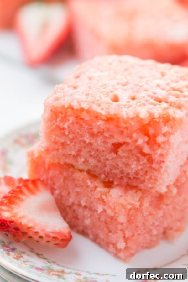 Refreshing Strawberry Lemonade Jello Cake with a vibrant pink hue.