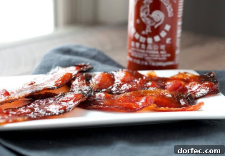 Crispy, sweet, and spicy Sriracha candied bacon strips, perfect as a snack or side dish.