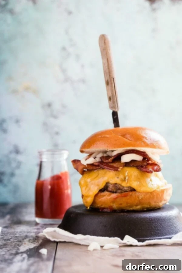 A classic cheddar bacon cheeseburger, featuring a juicy patty, crispy bacon, and melted cheddar cheese on a toasted bun.