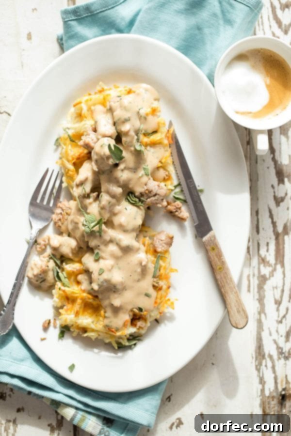 Crispy hashbrown waffles topped with a rich and savory rosemary sage sausage gravy, a hearty breakfast.
