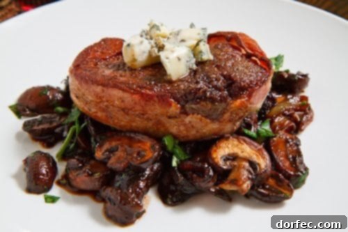A perfectly seared and smoked bacon-wrapped filet mignon, ready to be enjoyed as a gourmet meal.