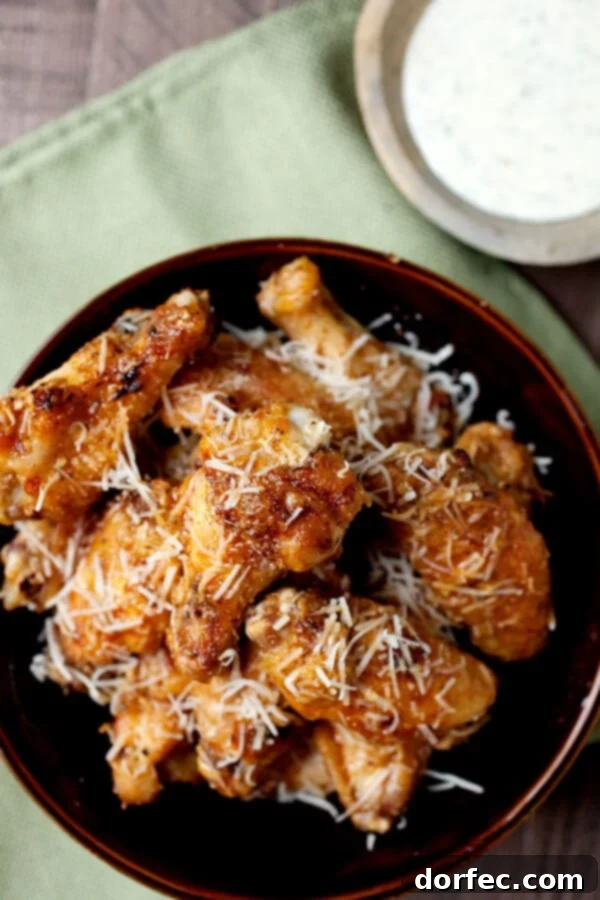 Irresistible garlic parmesan grilled chicken wings, perfectly charred and coated in a savory, cheesy sauce.