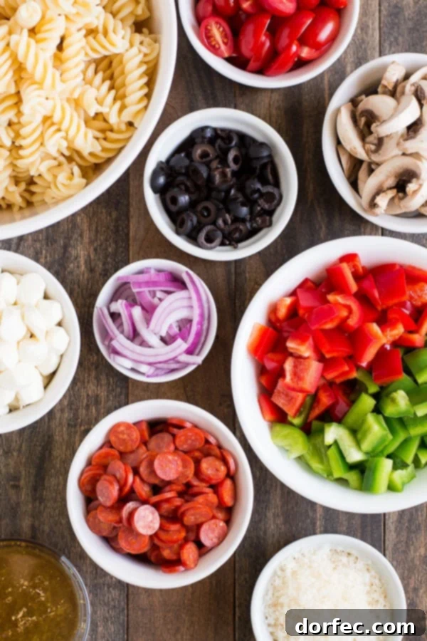 Serve Pizza Pasta Salad at your next barbecue and enjoy the delicious flavors of an Everything Pizza in this veggie, pepperoni, and cheese filled side dish. ohsweetbasil.com