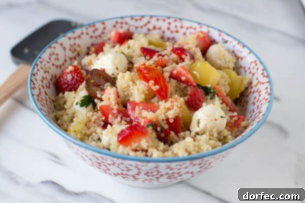 Berry Quinoa Salad - The perfect way to enjoy your summer without gobs of calories, with heirloom tomatoes, marinated mozzarella, and plump strawberries tossed in quinoa.